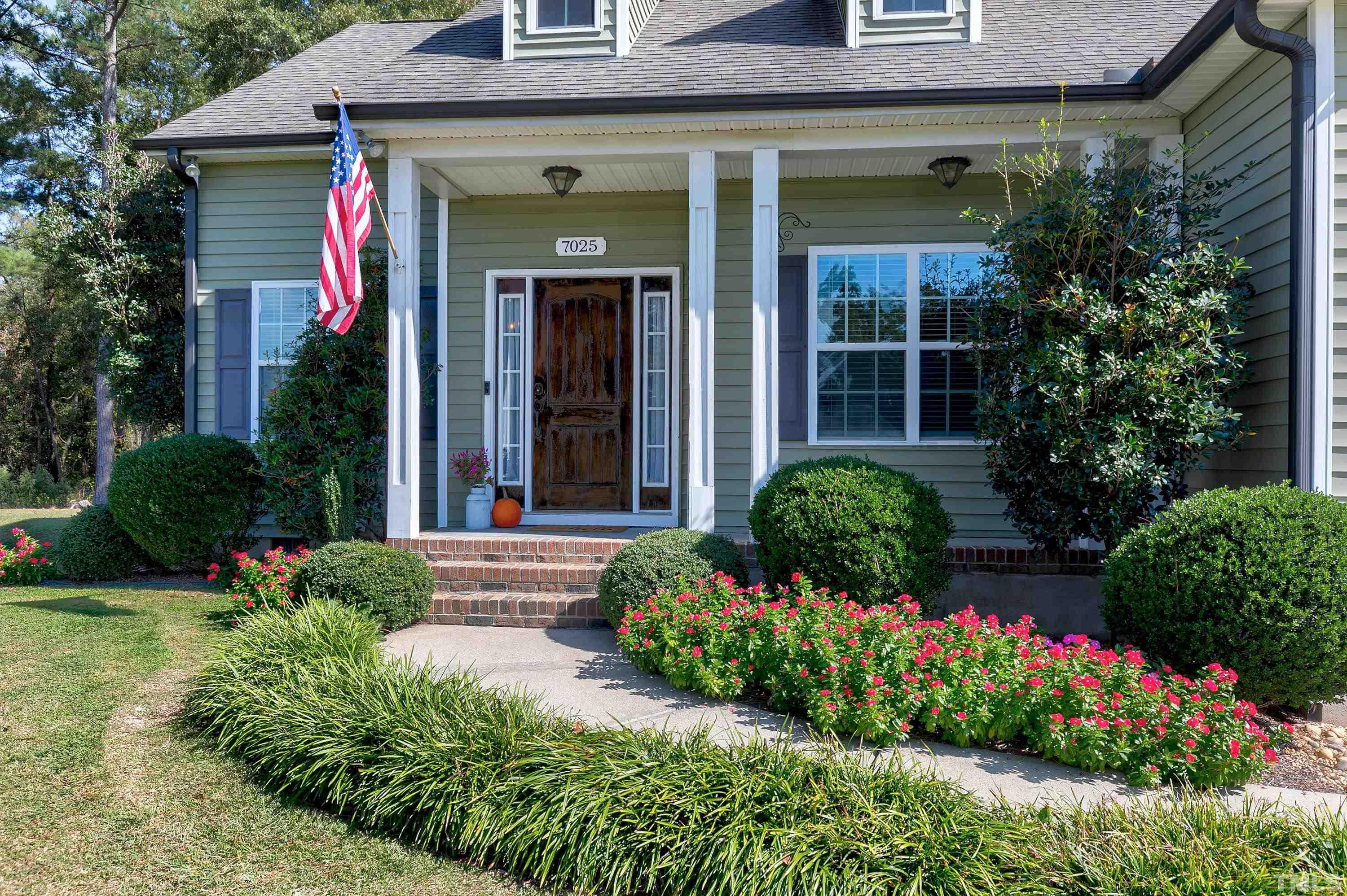 7025 Onslow Stephenson Road Willow Spring, NC 27592 - Photo 2 of 30 front view of a house with a yard