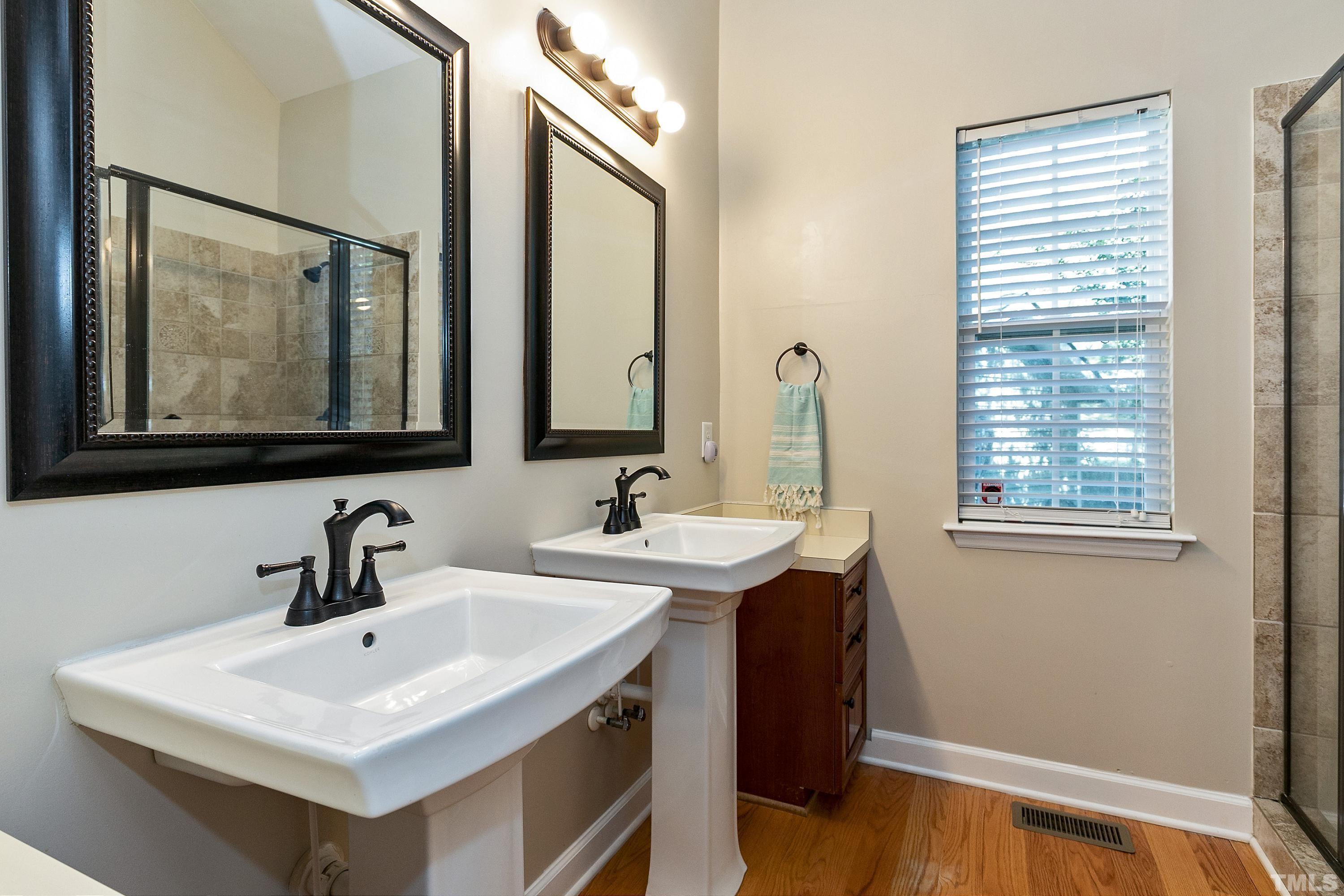 7025 Onslow Stephenson Road Willow Spring, NC 27592 - Photo 13 of 30 a bathroom with a sink and a mirror