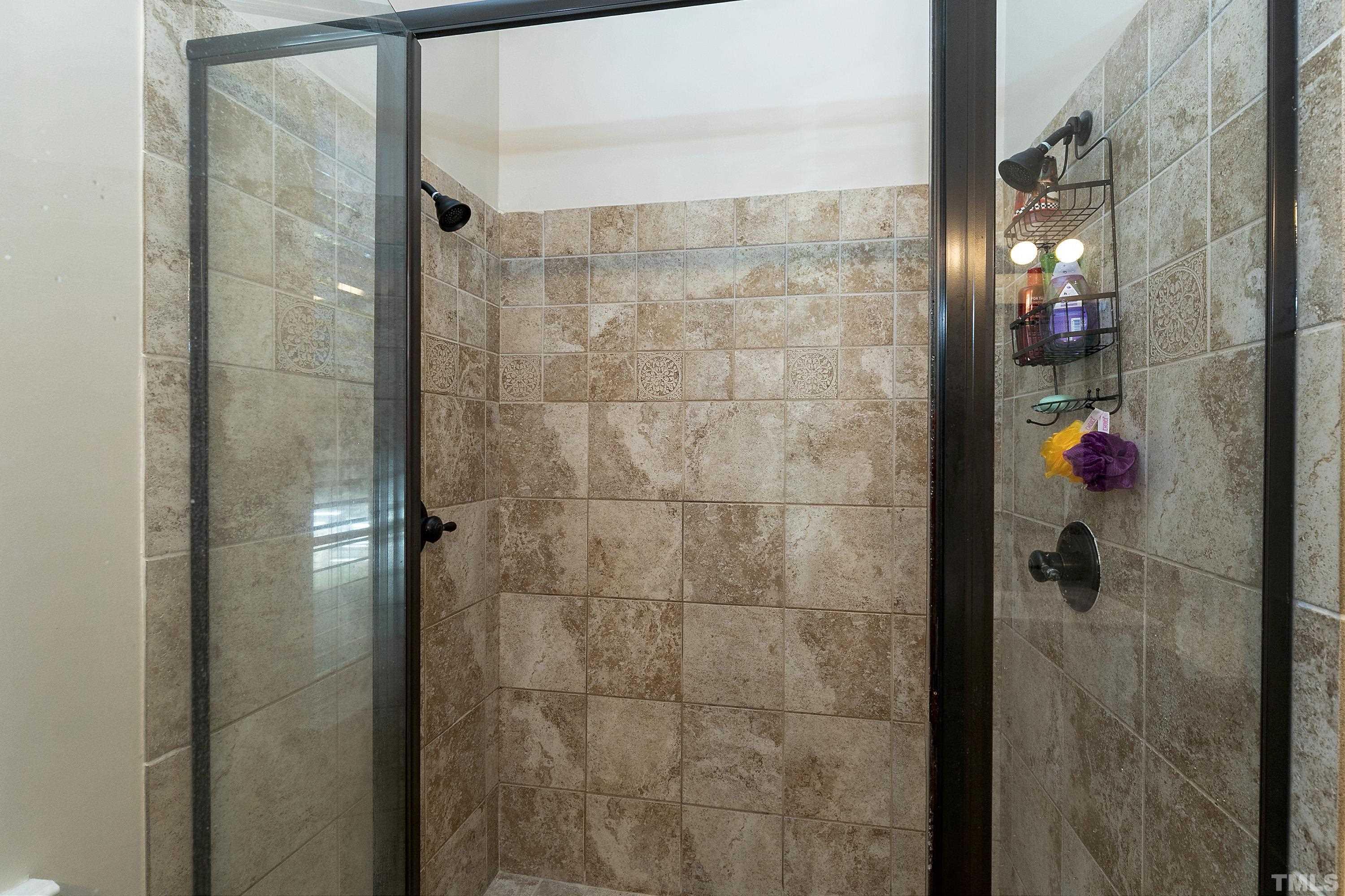 7025 Onslow Stephenson Road Willow Spring, NC 27592 - Photo 14 of 30 a bathroom with a shower and a sink
