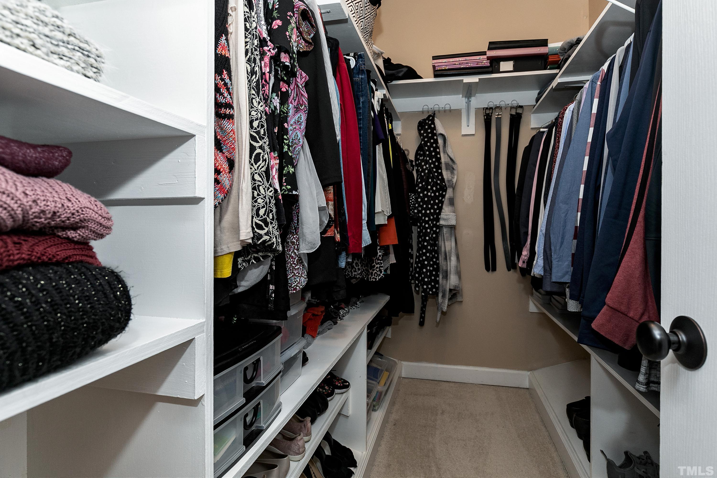 7025 Onslow Stephenson Road Willow Spring, NC 27592 - Photo 15 of 30 a view of walk in closet with clothes and shoes