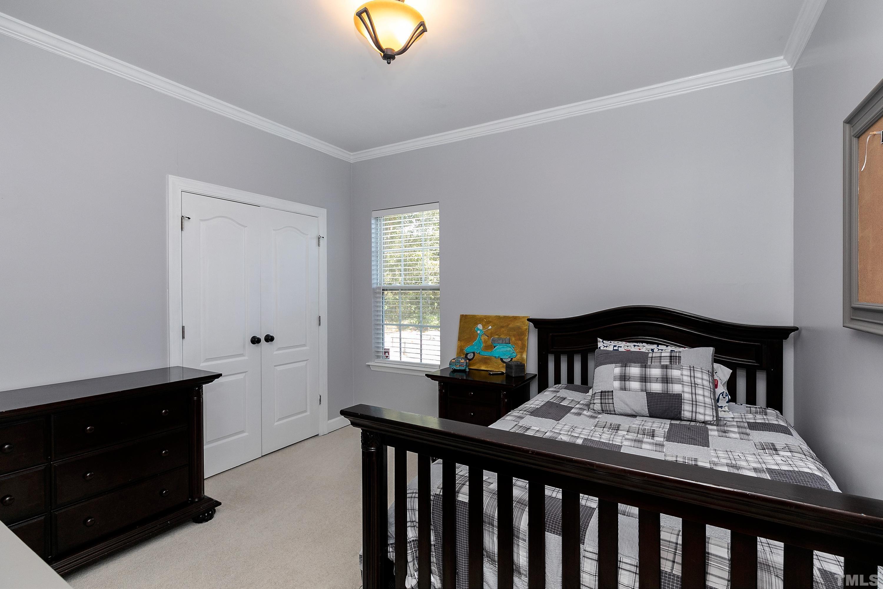 7025 Onslow Stephenson Road Willow Spring, NC 27592 - Photo 19 of 30 a bedroom with a bed and window