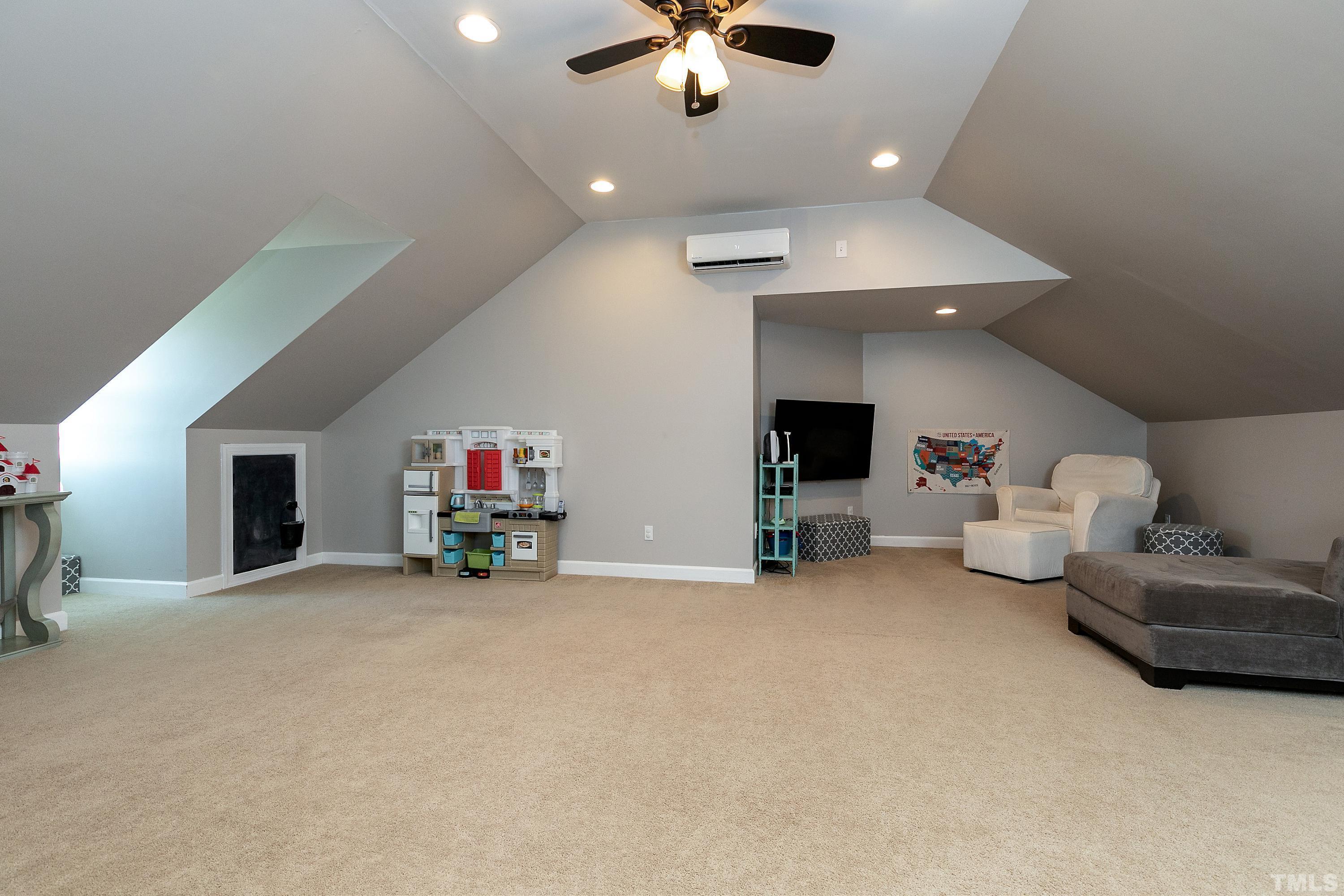 7025 Onslow Stephenson Road Willow Spring, NC 27592 - Photo 20 of 30 a living room with furniture and a fireplace
