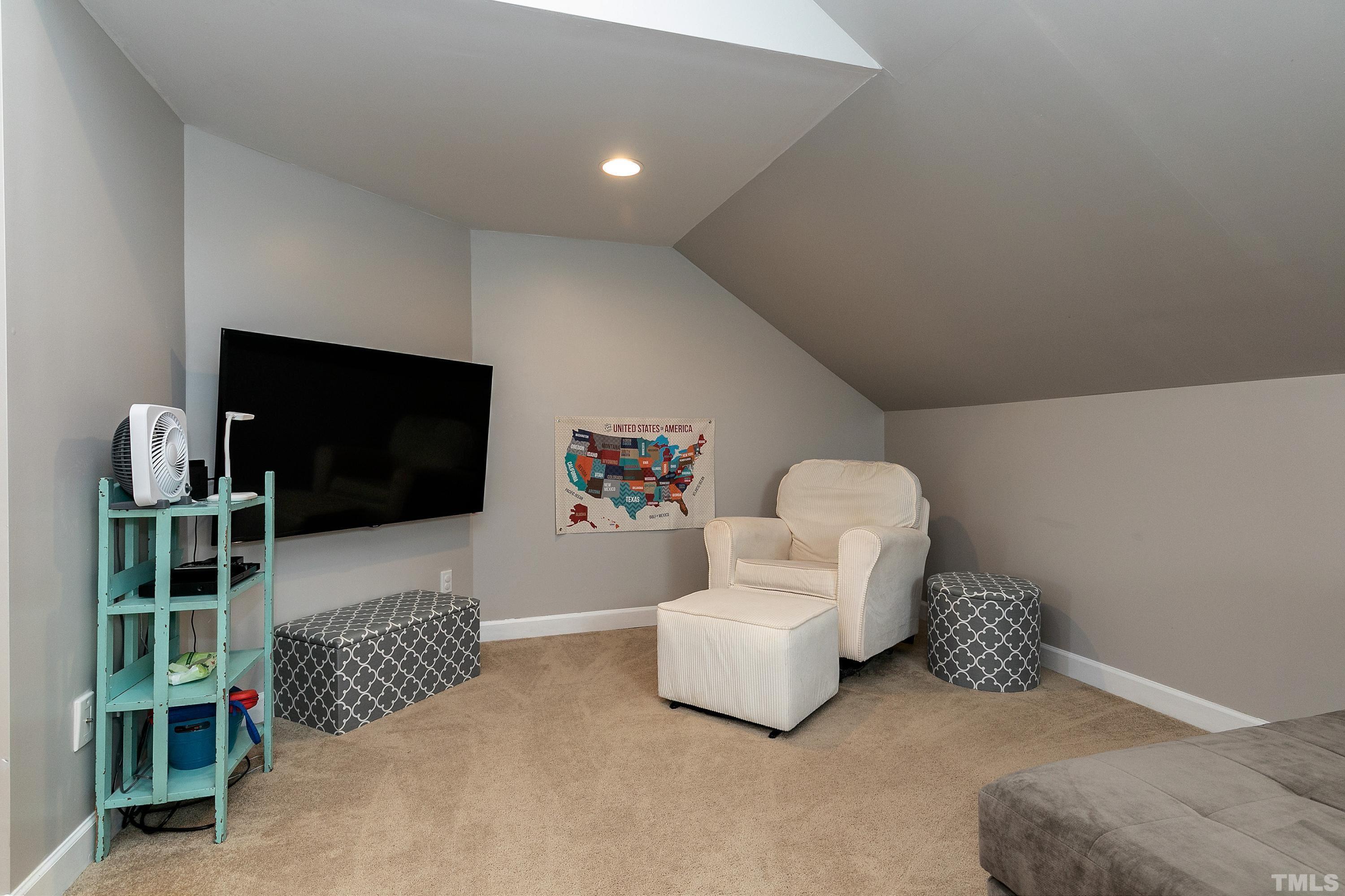 7025 Onslow Stephenson Road Willow Spring, NC 27592 - Photo 21 of 30 a living room with furniture and a flat screen tv