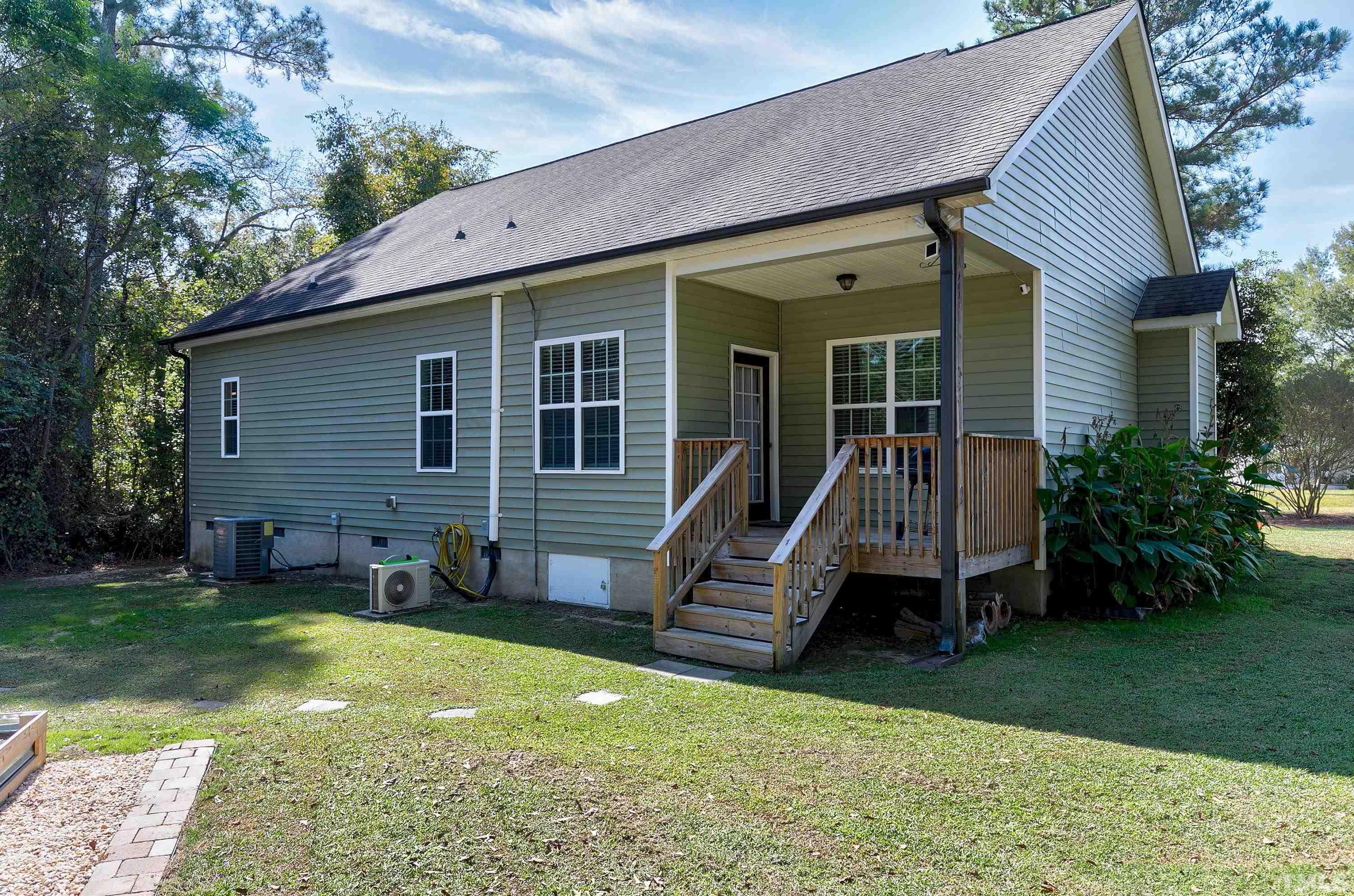 7025 Onslow Stephenson Road Willow Spring, NC 27592 - Photo 24 of 30 a view of a house with a backyard