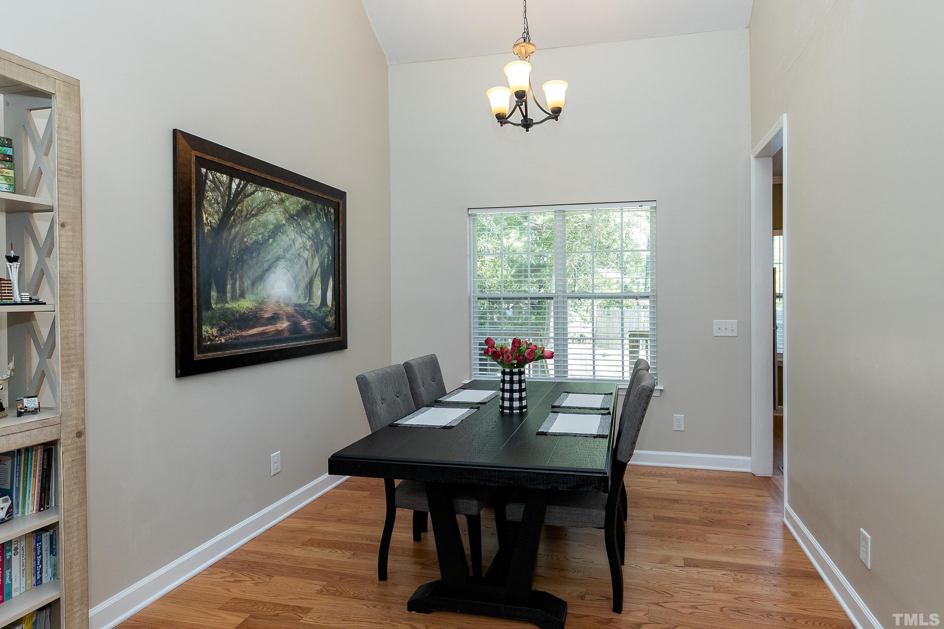 7025 Onslow Stephenson Road Willow Spring, NC 27592 - Photo 6 of 30 a view of a dining room with furniture window and wooden floor