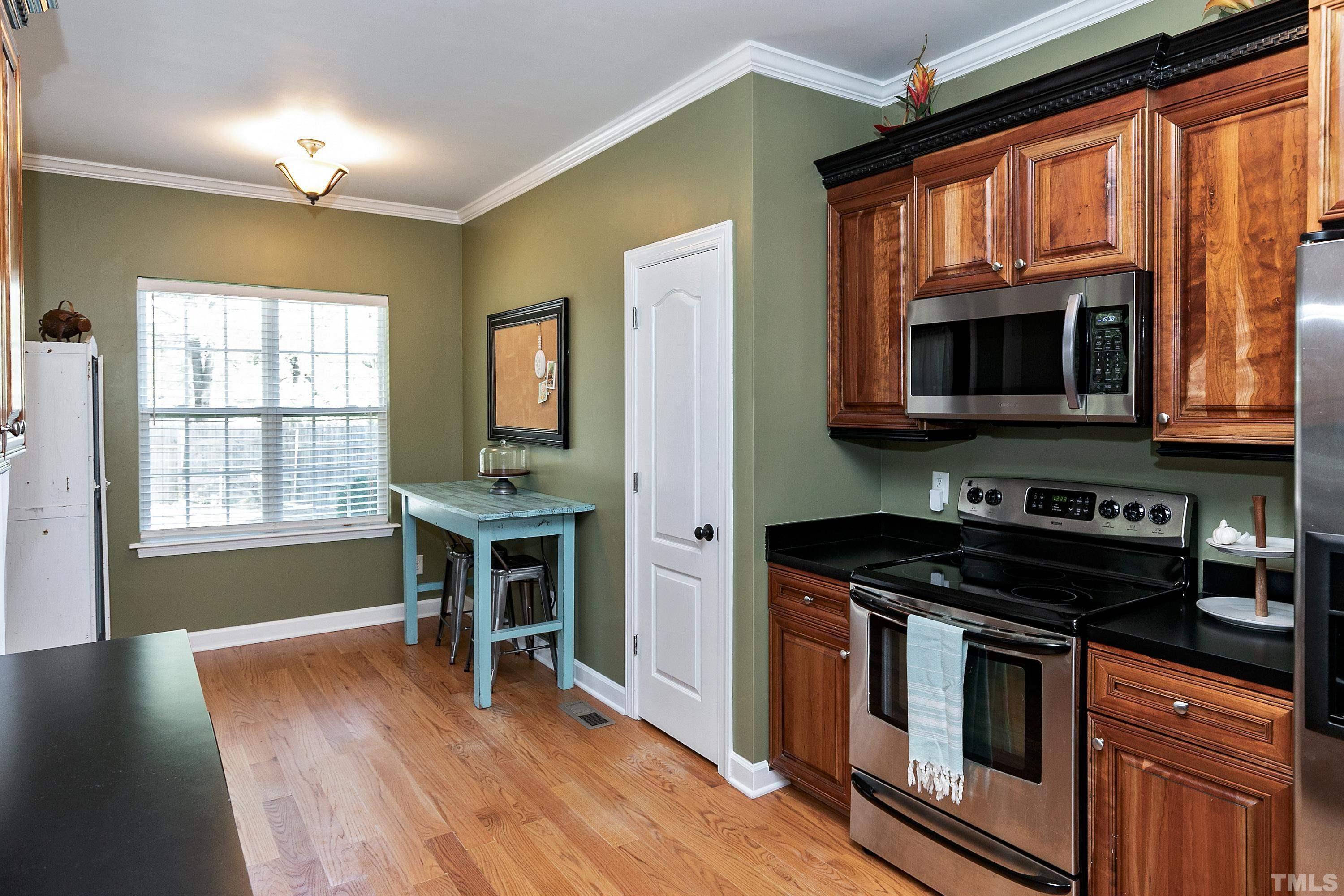 7025 Onslow Stephenson Road Willow Spring, NC 27592 - Photo 7 of 30 a kitchen with stainless steel appliances granite countertop a stove a sink and a microwave