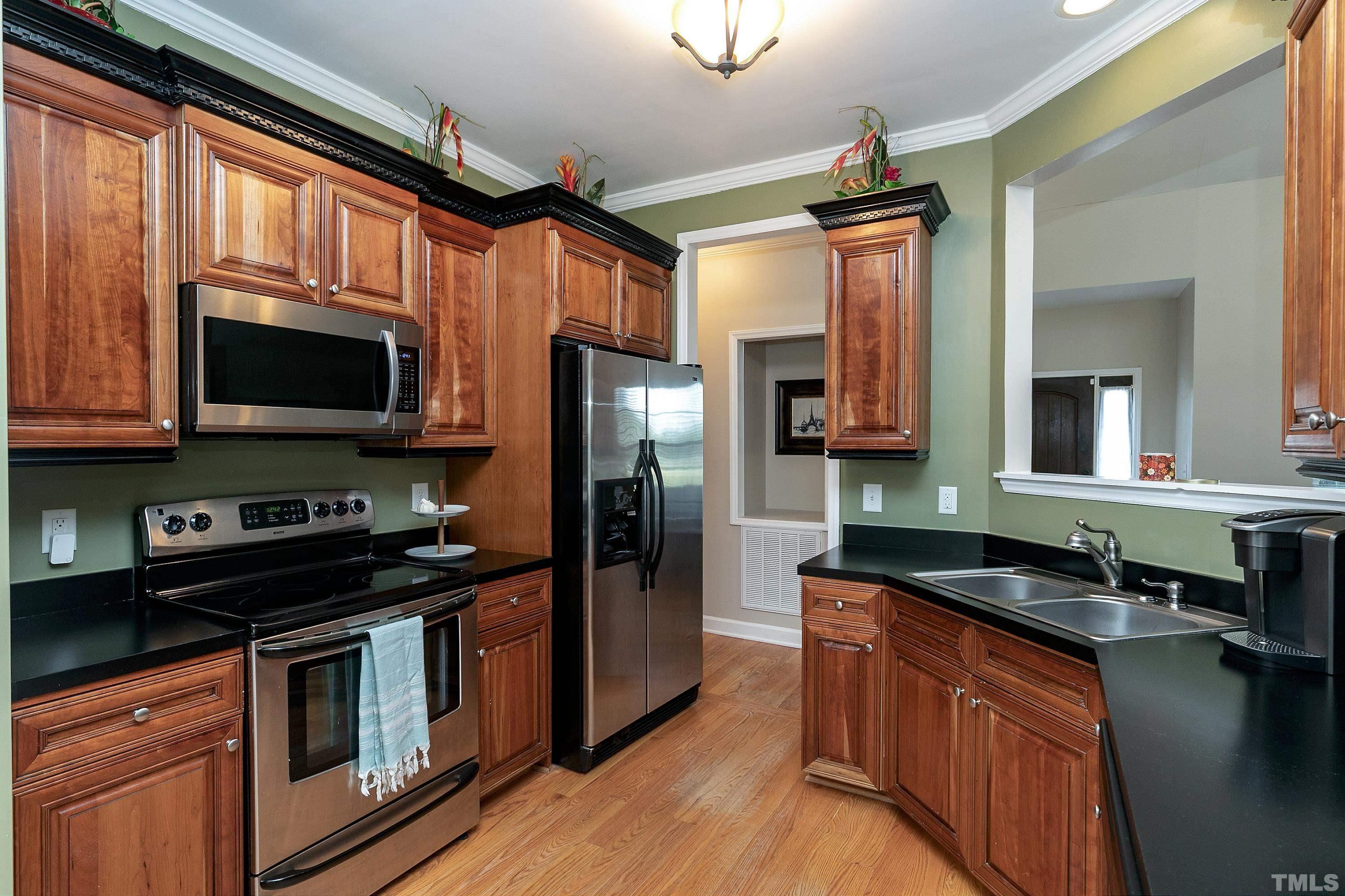 7025 Onslow Stephenson Road Willow Spring, NC 27592 - Photo 9 of 30 a kitchen with stainless steel appliances granite countertop a stove a sink and a microwave