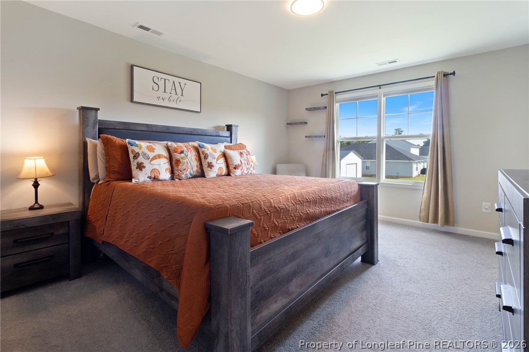 1368 Talmage Road St. Pauls, NC 28384 - Photo 11 of 26 a bedroom with a bed and a night stand
