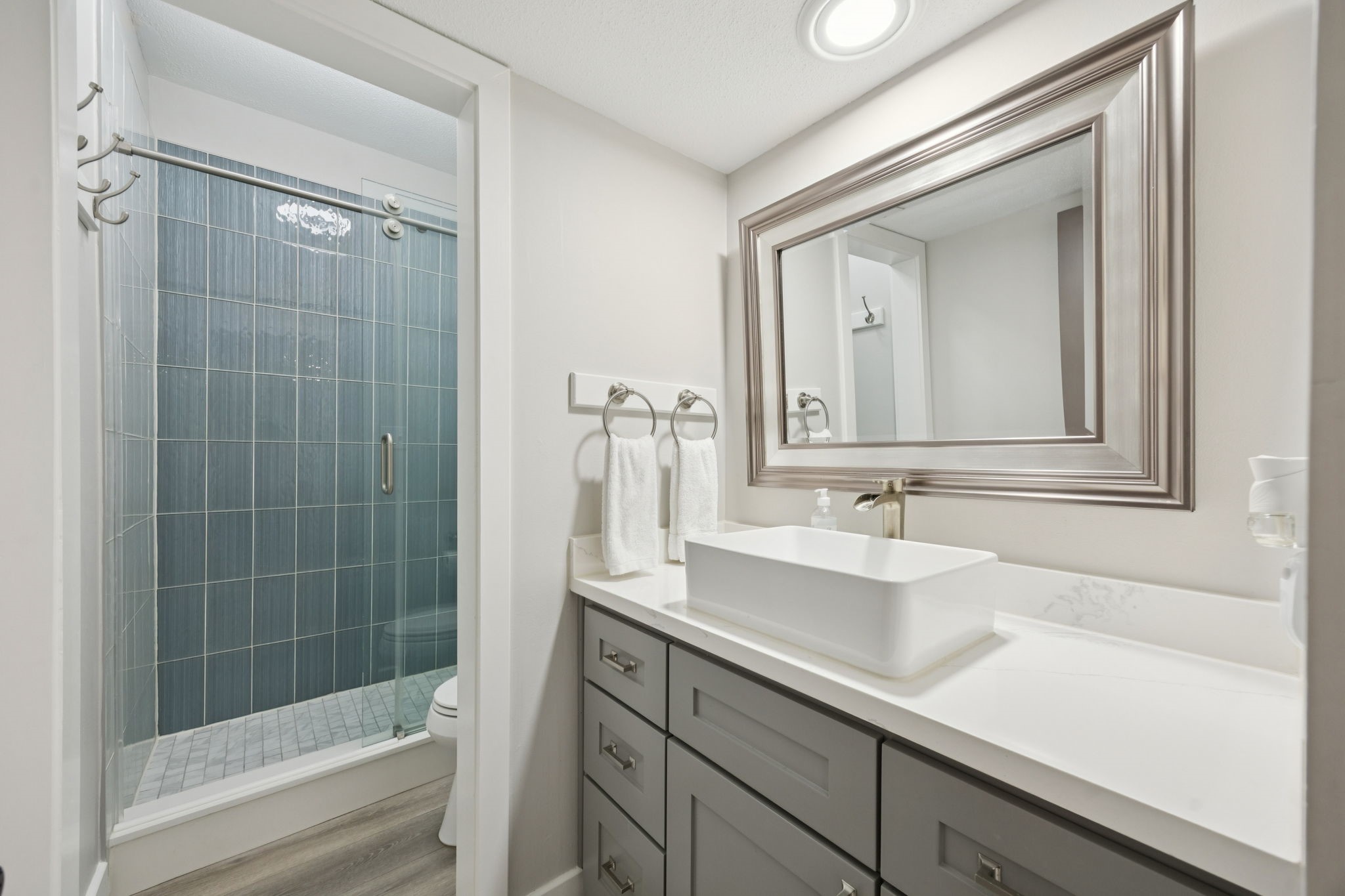 500 River Road, Unit 106 Montgomery, TX 77356 - Photo 21 of 32 Second bathroom located off the hallway is perfect for guests. This bathroom also features quartz countertops, raised sinks, additional pull-out drawer storage.