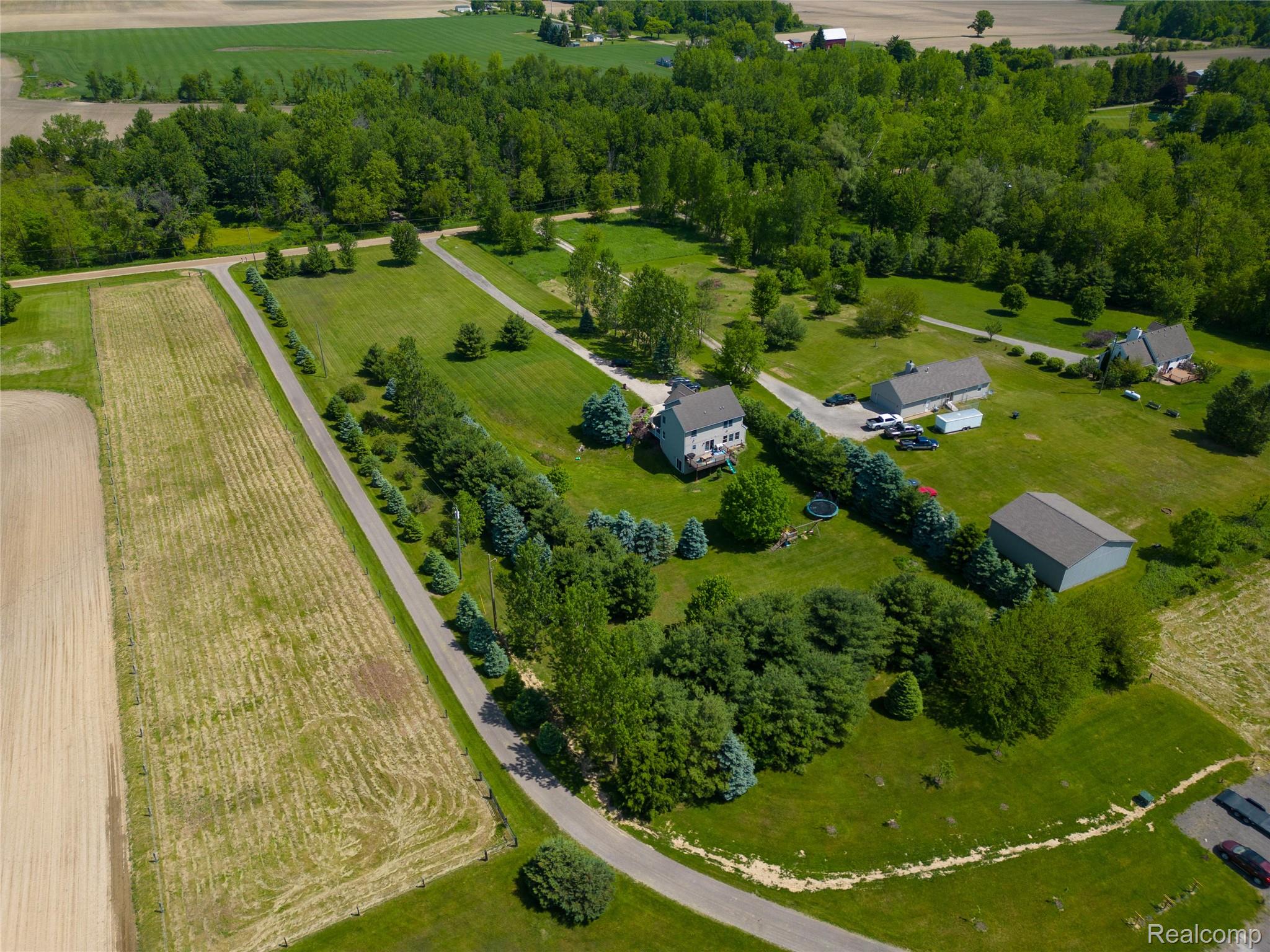 9191 Judd Road Fowlerville, MI 48836 - Photo 72 of 74 Expansive property featuring a main residence, a secondary structure, and a detached outbuilding