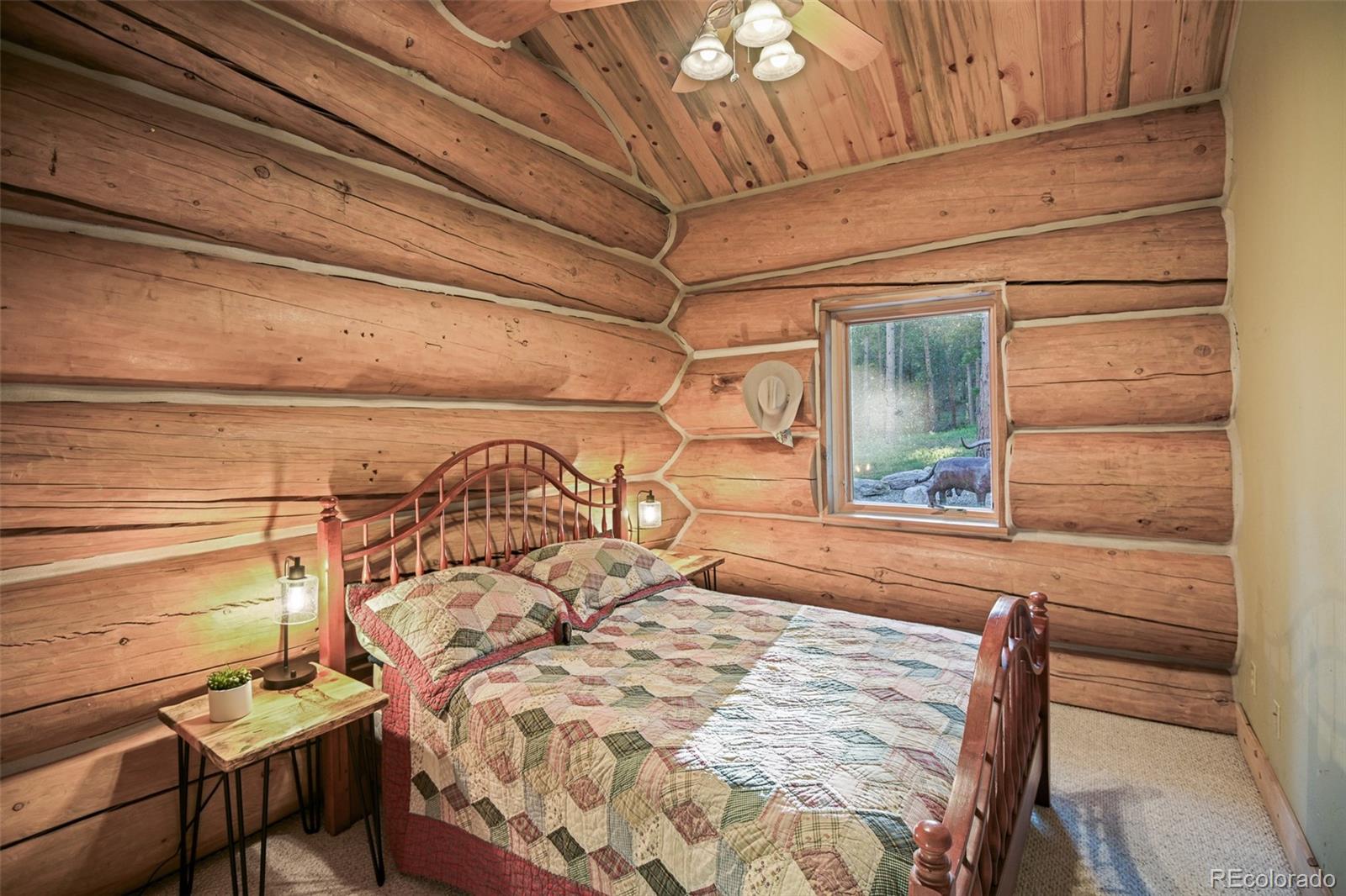 13434 Baird Road Conifer, CO 80433 - Photo 18 of 36 a bed sitting in a bedroom next to a window