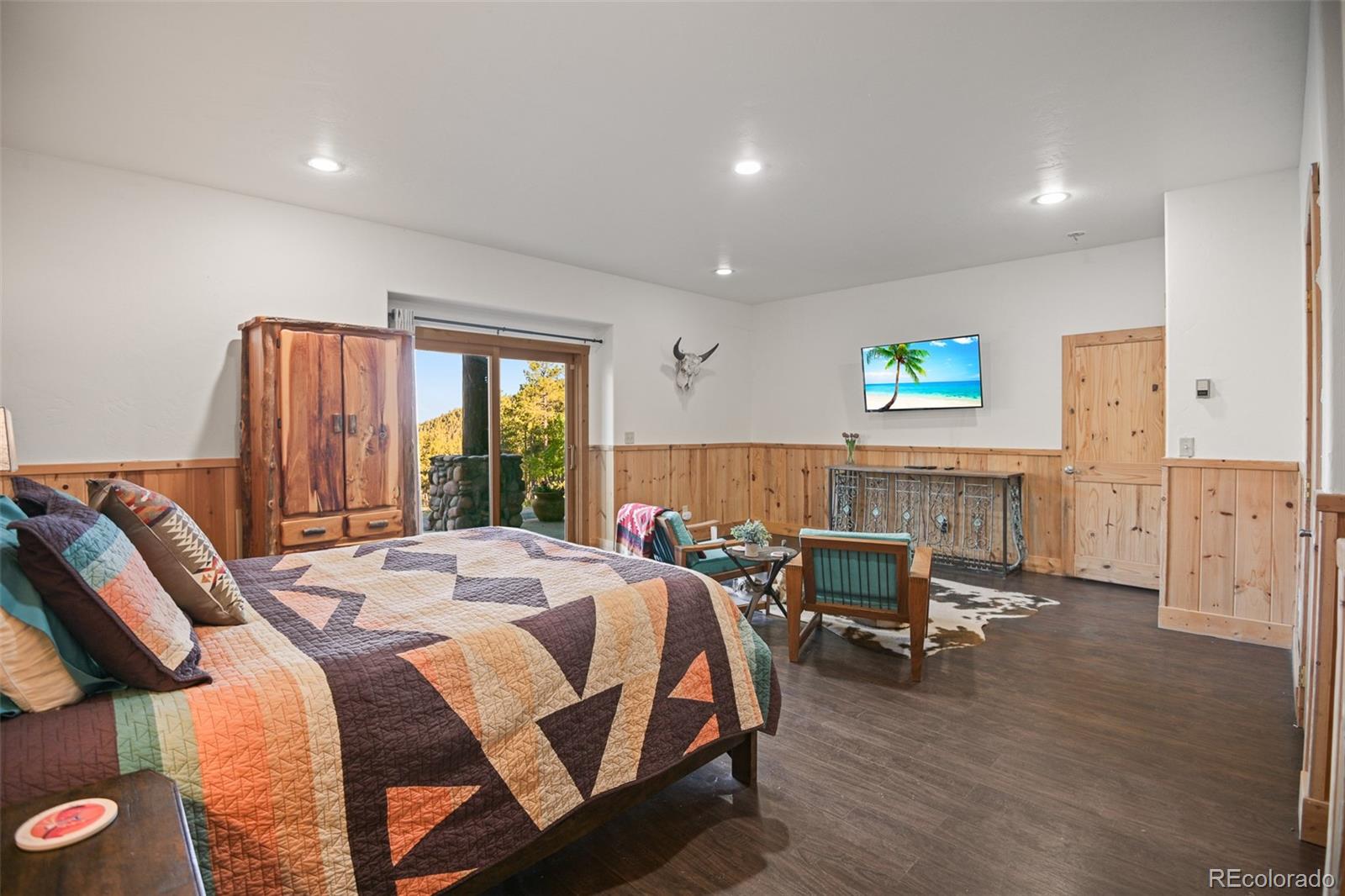 13434 Baird Road Conifer, CO 80433 - Photo 23 of 36 a bed room with a bed and a television