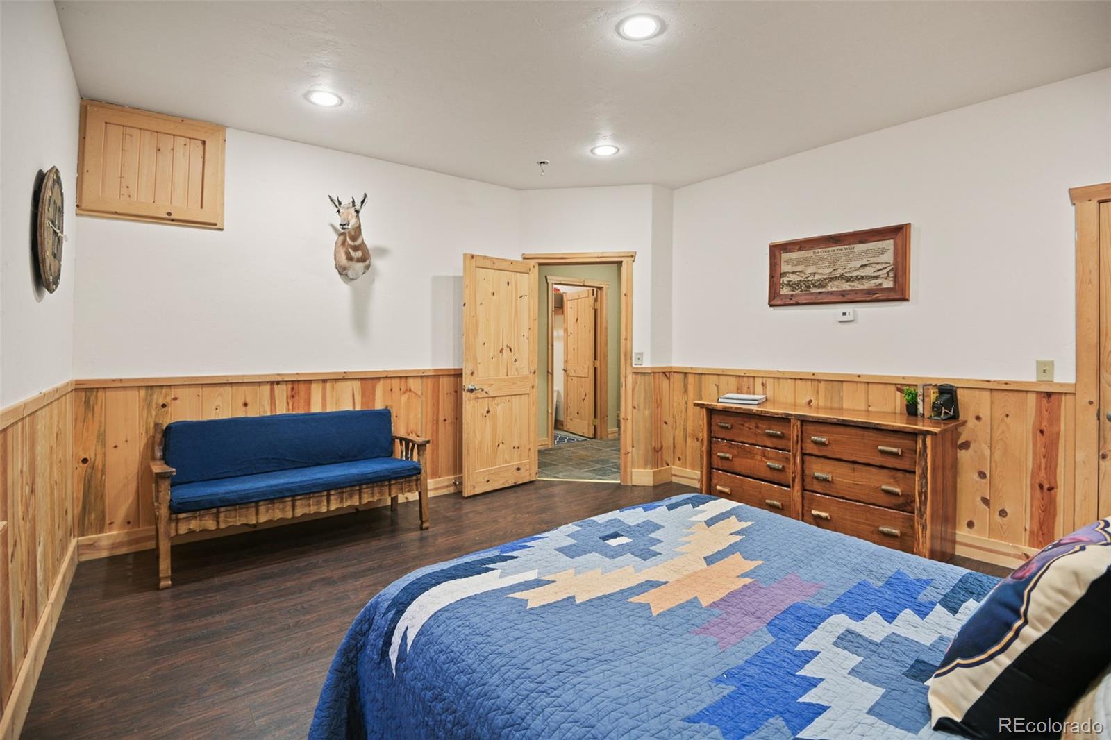 13434 Baird Road Conifer, CO 80433 - Photo 28 of 36 a bedroom with a bed and a dresser