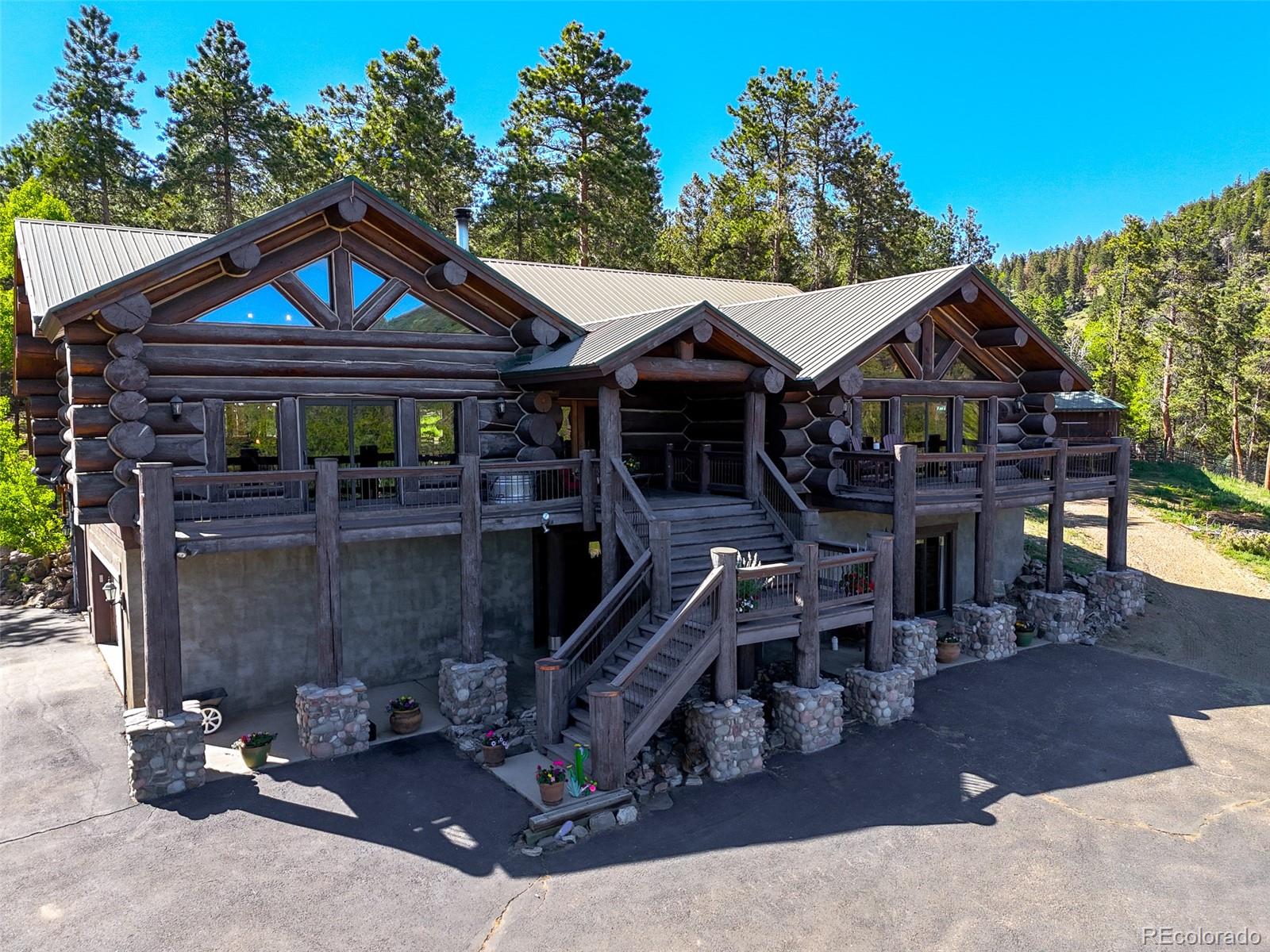 13434 Baird Road Conifer, CO 80433 - Photo 29 of 36 a view of a house with wooden deck