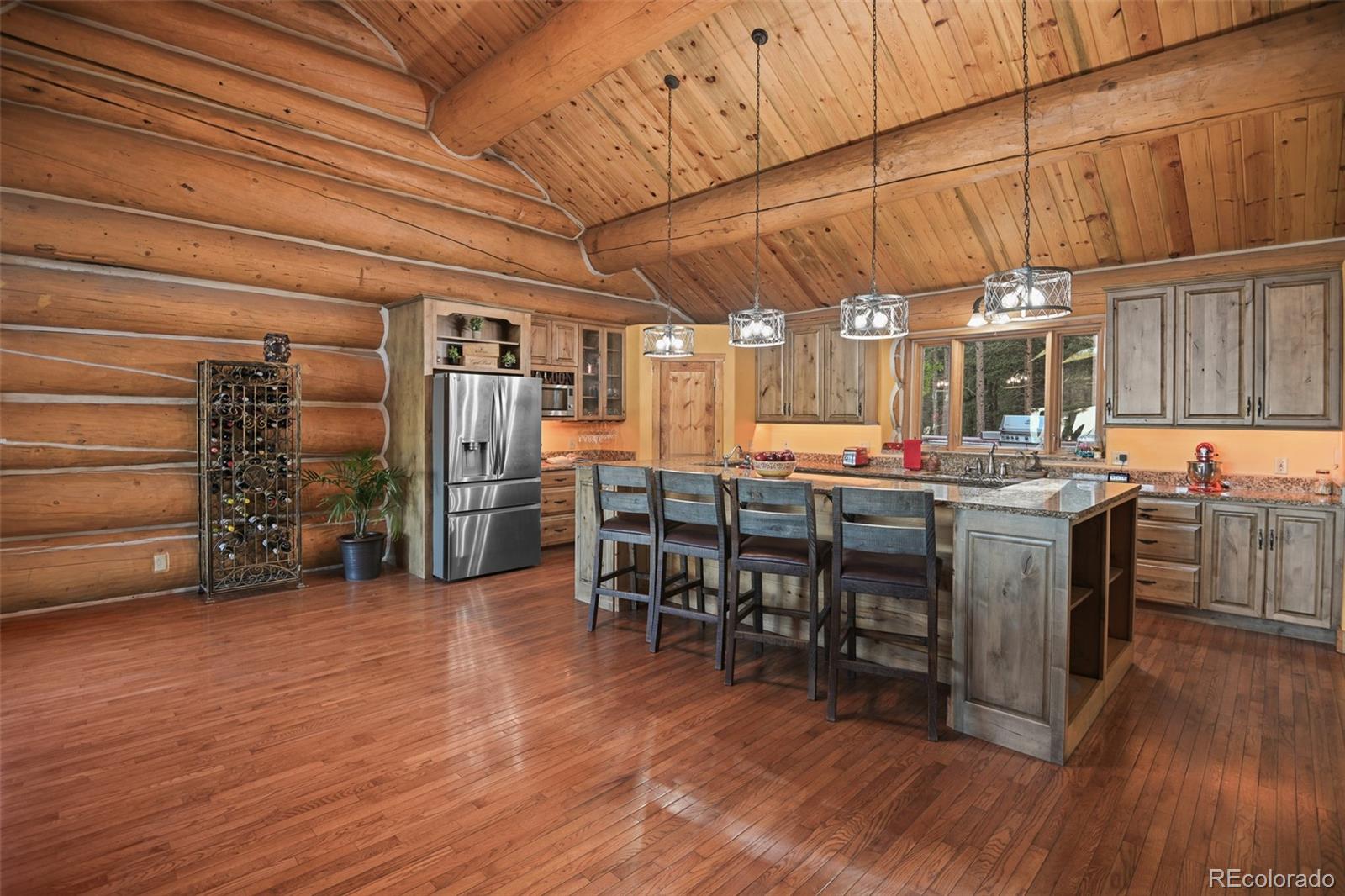 13434 Baird Road Conifer, CO 80433 - Photo 10 of 36 a kitchen with lots of counter top space and stainless steel appliances