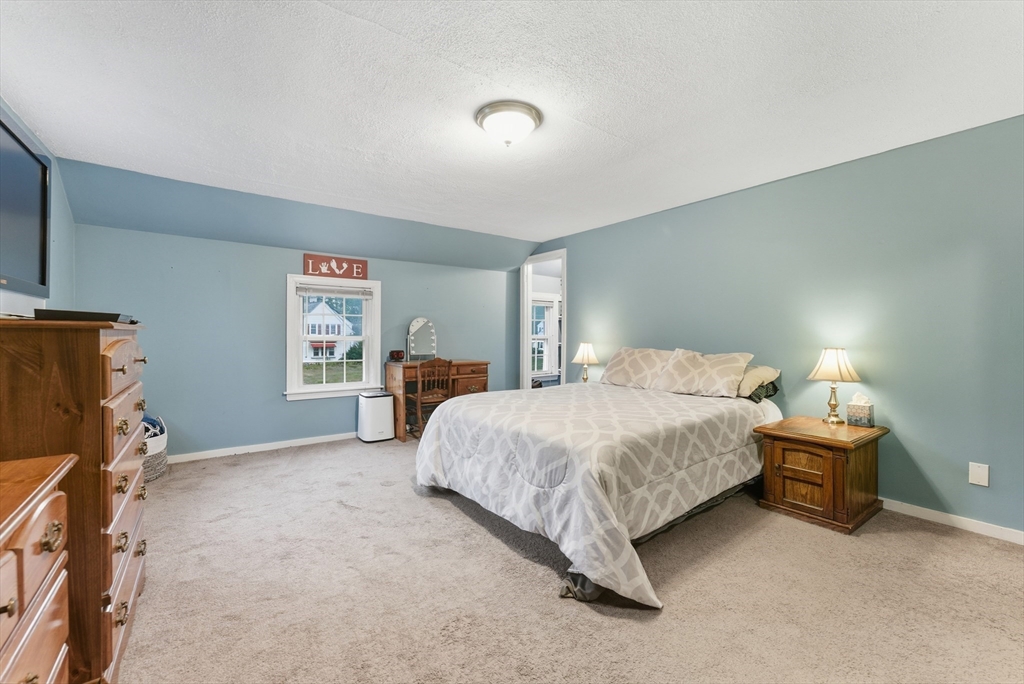 54 Churchill Road West Springfield, MA 01089 - Photo 19 of 42 a spacious bedroom with a bed and a window