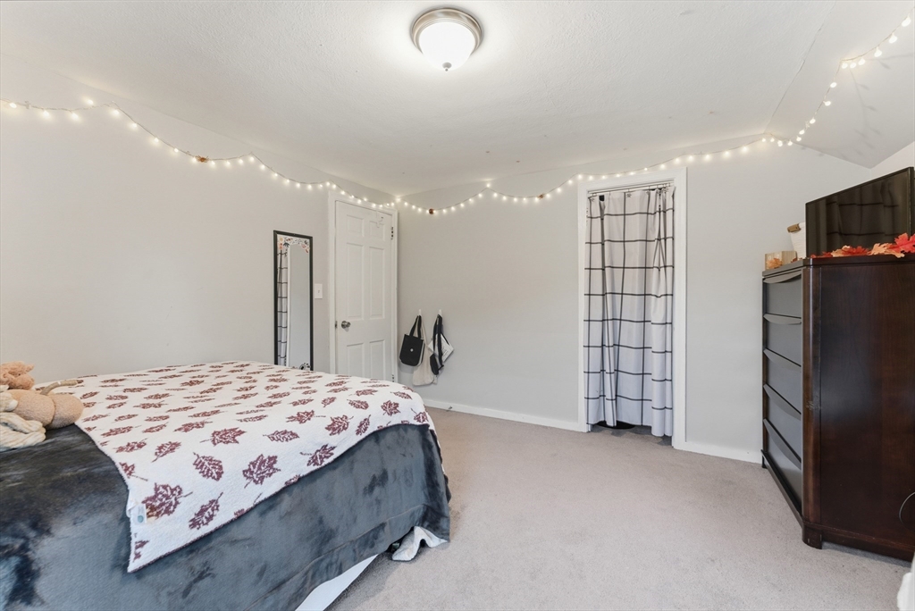 54 Churchill Road West Springfield, MA 01089 - Photo 25 of 42 a bedroom with a bed and a flat screen tv