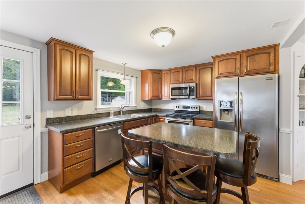 54 Churchill Road West Springfield, MA 01089 - Photo 5 of 42 a kitchen with a table chairs refrigerator and cabinets