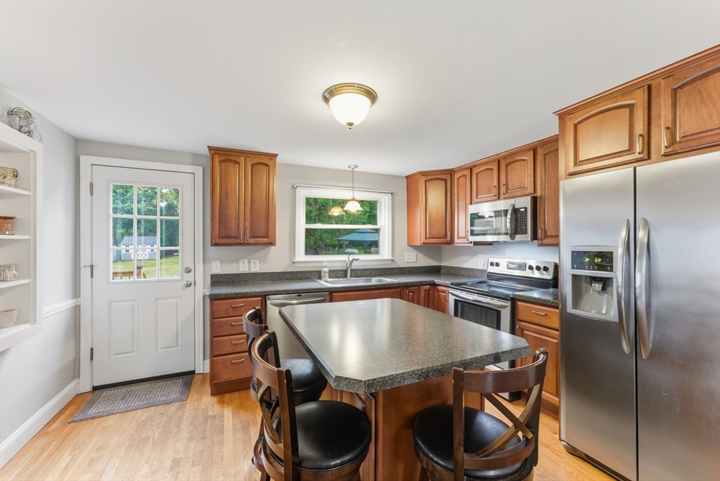 54 Churchill Road West Springfield, MA 01089 - Photo 6 of 42 a kitchen with a stove a sink and a refrigerator