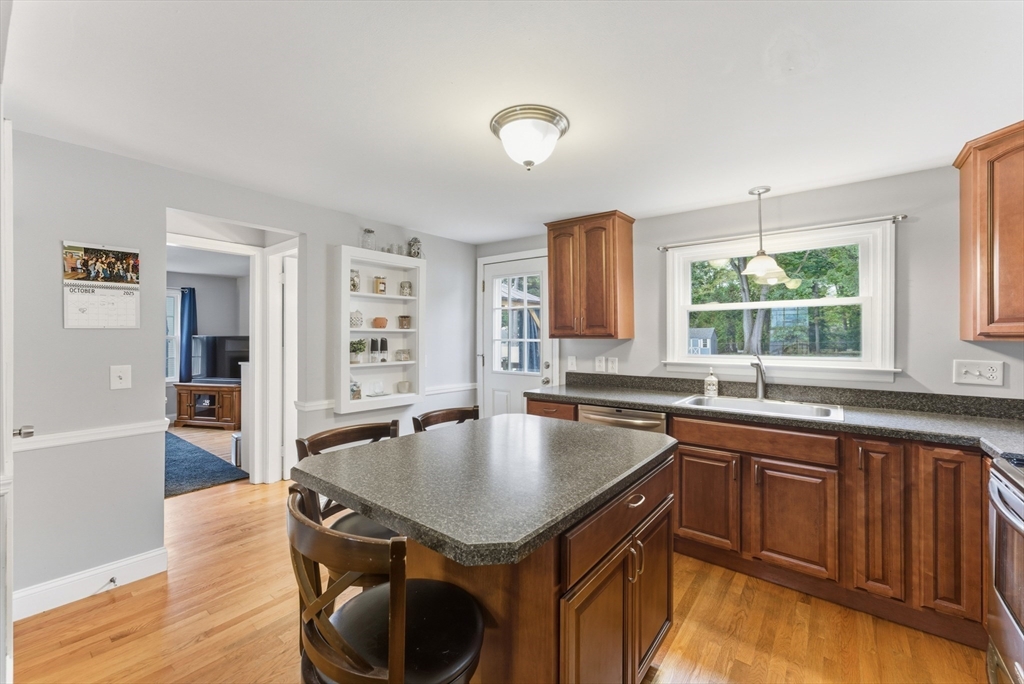 54 Churchill Road West Springfield, MA 01089 - Photo 8 of 42 a kitchen with a stove a sink dishwasher and a refrigerator with wooden floor