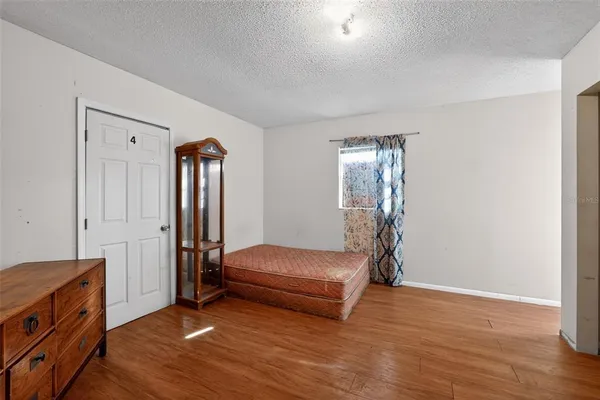 a bedroom with furniture and a window
