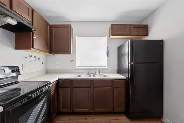 a kitchen with a sink and a refrigerator
