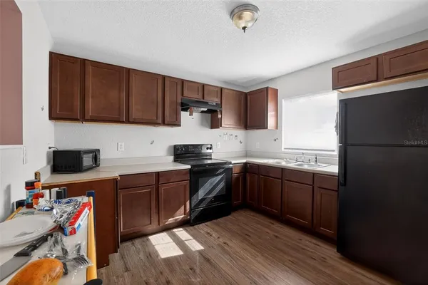 a kitchen with a sink a stove and refrigerator