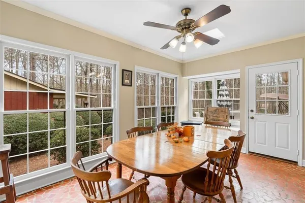 a view of a dining room with furniture and chandelier