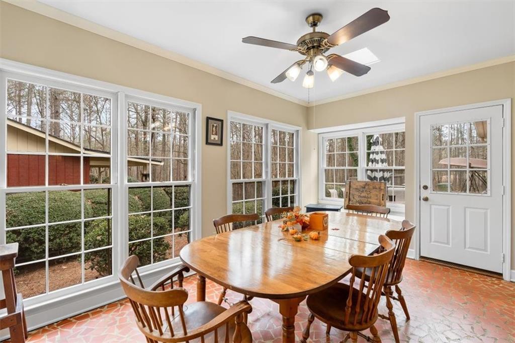 455 M M Sanders Road Buchanan, GA 30113 - Photo 12 of 65 a dining room with furniture a rug and a large window
