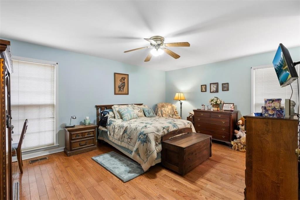 455 M M Sanders Road Buchanan, GA 30113 - Photo 24 of 65 a spacious bedroom with a bed and a flat screen tv