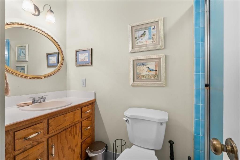 455 M M Sanders Road Buchanan, GA 30113 - Photo 31 of 65 a bathroom with a toilet a sink and mirror