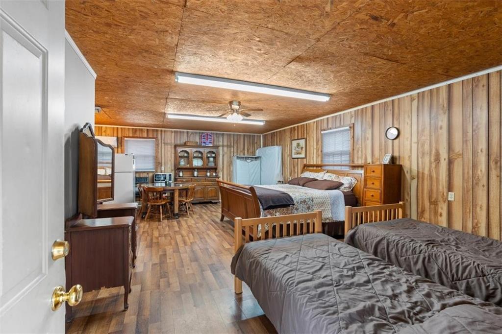 455 M M Sanders Road Buchanan, GA 30113 - Photo 35 of 65 a bedroom with a bed and wooden floor