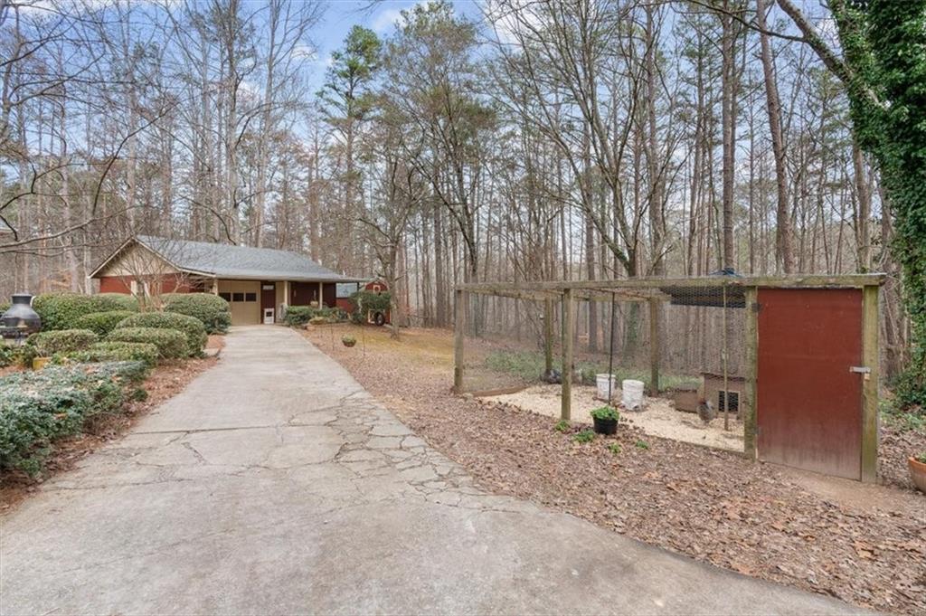 455 M M Sanders Road Buchanan, GA 30113 - Photo 4 of 65 a view of backyard with a table and chairs and a large tree