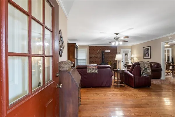 a living room with furniture ceiling fan and a rug