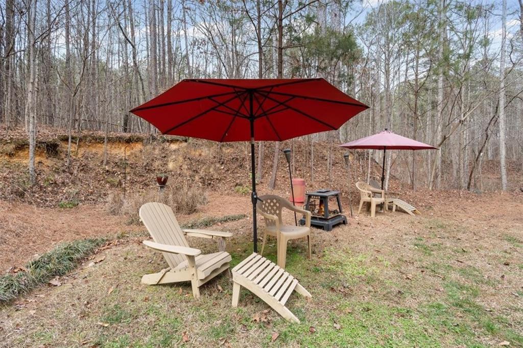 455 M M Sanders Road Buchanan, GA 30113 - Photo 51 of 65 a view of a backyard with a patio and outdoor seating