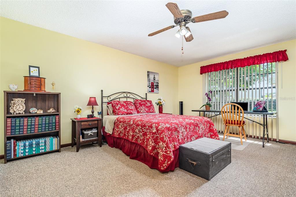 155 11th Avenue Osteen, FL 32764 - Photo 13 of 42 a bedroom with a bed and a chandelier