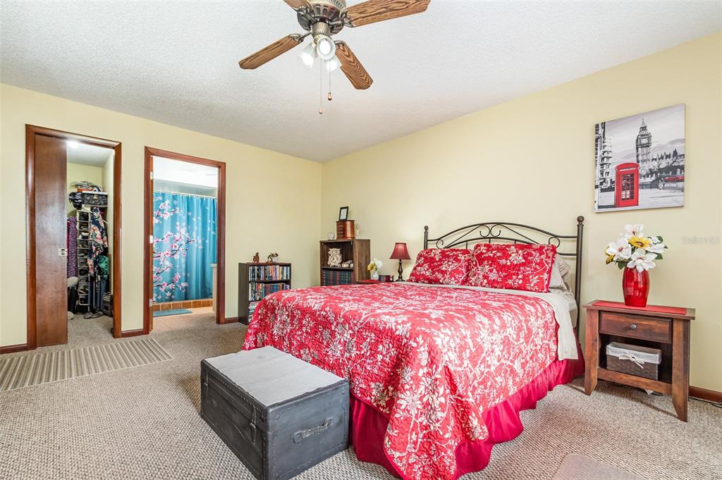 155 11th Avenue Osteen, FL 32764 - Photo 14 of 42 a bedroom with a bed and a chandelier