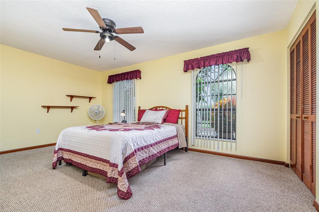 155 11th Avenue Osteen, FL 32764 - Photo 16 of 42 a spacious bedroom with a bed and a window