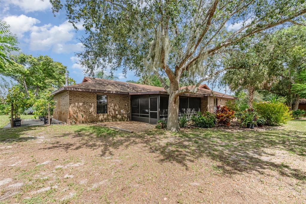 155 11th Avenue Osteen, FL 32764 - Photo 23 of 42 a front view of a house with a garden