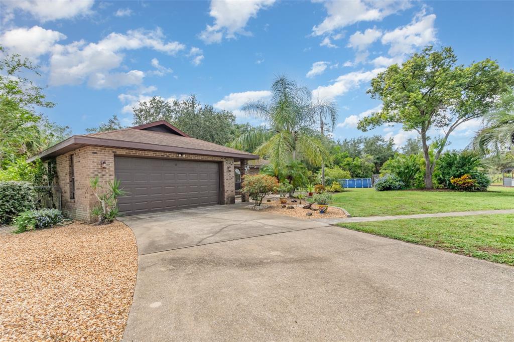 155 11th Avenue Osteen, FL 32764 - Photo 3 of 42 a front view of house with yard and trees