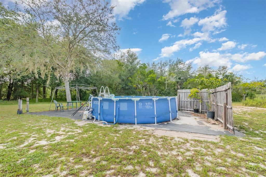 155 11th Avenue Osteen, FL 32764 - Photo 33 of 42 a view of a backyard with wooden fence and large trees
