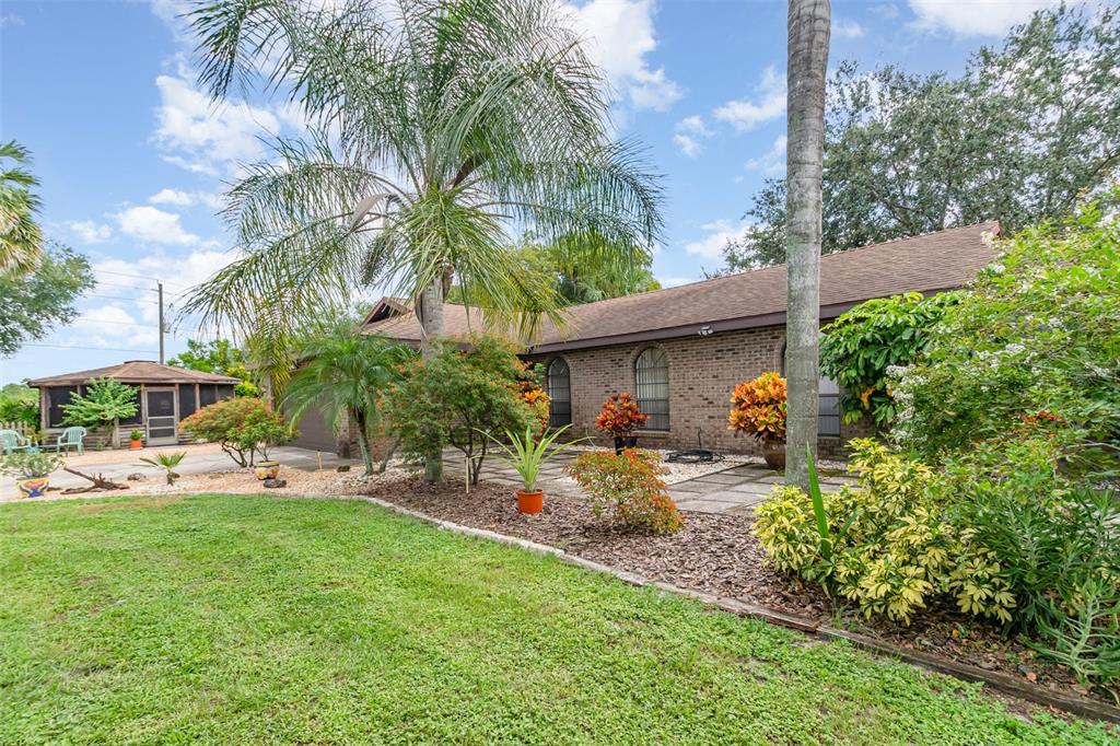 155 11th Avenue Osteen, FL 32764 - Photo 4 of 42 a view of a house with patio and garden