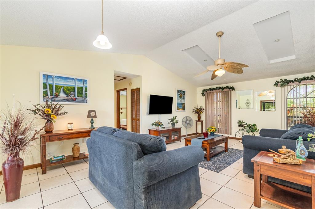 155 11th Avenue Osteen, FL 32764 - Photo 6 of 42 a living room with furniture and a flat screen tv