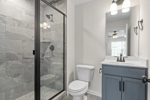 a bathroom with a toilet a sink and shower