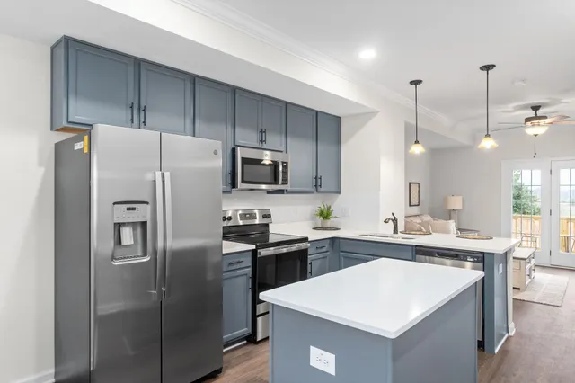 a kitchen with stainless steel appliances a refrigerator sink and microwave