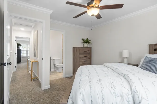 a spacious bedroom with a bed and a chandelier