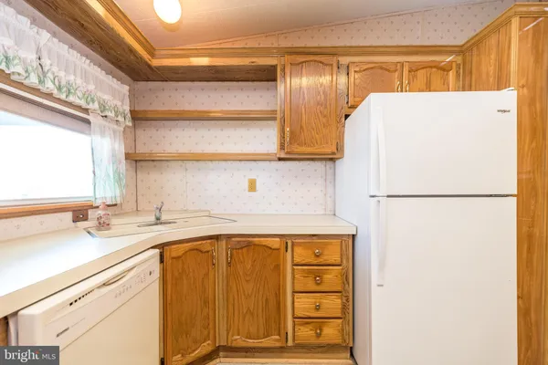a kitchen with a refrigerator and a sink