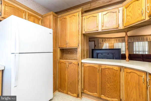 a kitchen with a refrigerator and a refrigerator