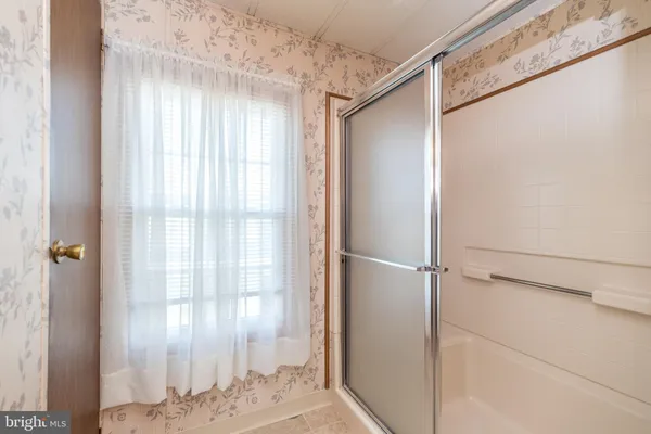 a view of a bathroom with a shower and a sink