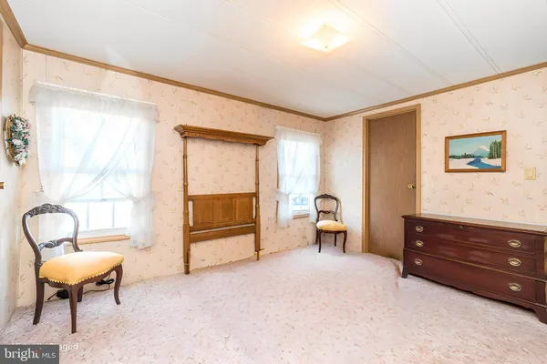 a view of a livingroom with furniture and a window